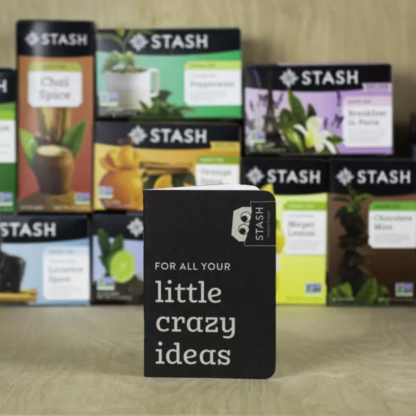 A notebook in front of tea boxes